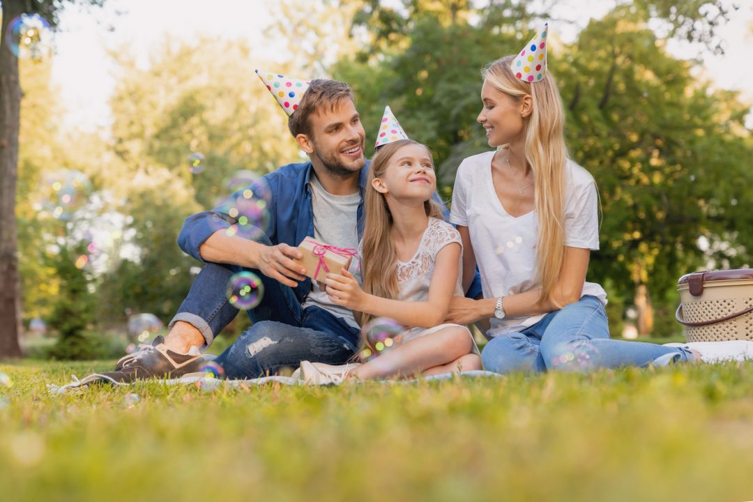 happy family of three celebrating birthday party in the park happy birthday 1 1